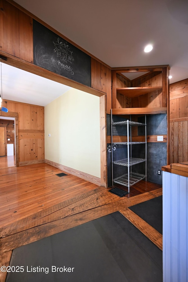 1819 Eastern Pkwy, Louisville, KY 40204 - unfurnished living room featuring hardwood / wood-style floors, wooden walls, and recessed lighting