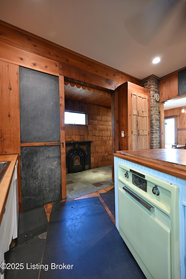 1819 Eastern Pkwy, Louisville, KY 40204 - kitchen featuring wood walls and a wood stove