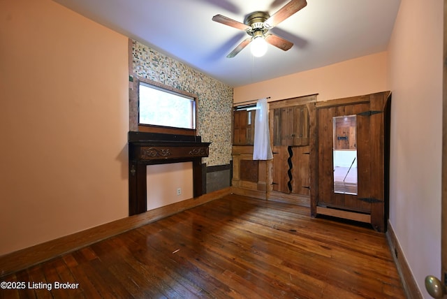 1819 Eastern Pkwy, Louisville, KY 40204 - unfurnished living room with baseboard heating, hardwood / wood-style flooring, and ceiling fan