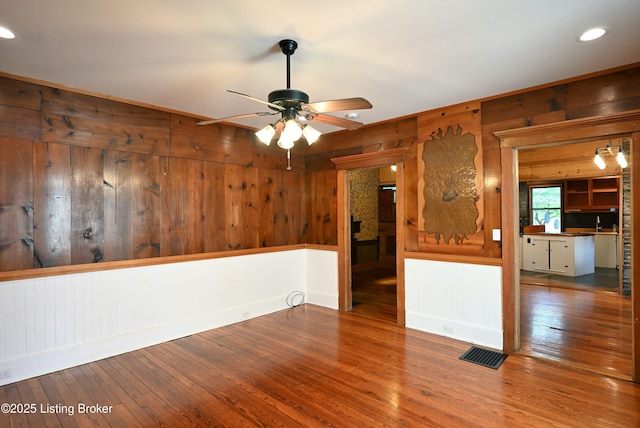 1819 Eastern Pkwy, Louisville, KY 40204 - empty room with wood walls, hardwood / wood-style floors, ceiling fan, and recessed lighting
