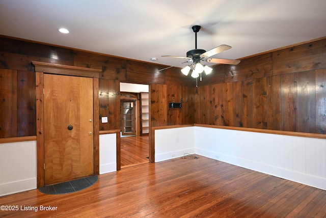1819 Eastern Pkwy, Louisville, KY 40204 - unfurnished room with wood walls, wood finished floors, a ceiling fan, and recessed lighting