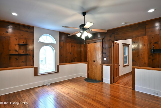 1819 Eastern Pkwy, Louisville, KY 40204 - unfurnished room featuring hardwood / wood-style flooring, wood walls, a ceiling fan, a smoke detector, and recessed lighting