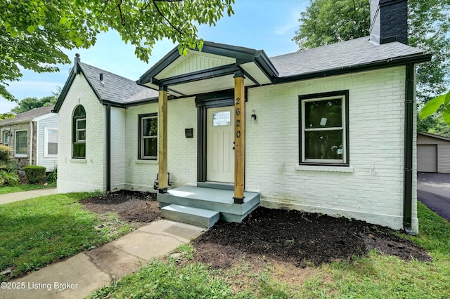 2620 Algonquin Pkwy, Louisville, KY 40210 - view of front of property with brick siding, a chimney, and a shingled roof