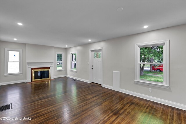 2620 Algonquin Pkwy, Louisville, KY 40210 - unfurnished living room featuring healthy amount of natural light, dark wood-style floors, recessed lighting, and a fireplace with flush hearth