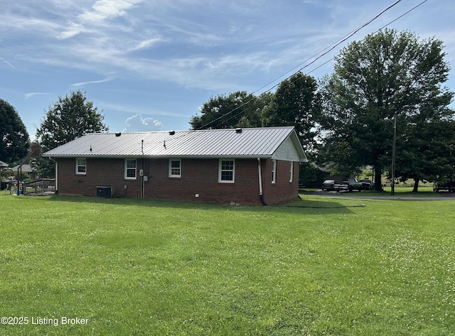 106 Sunflower Dr, Campbellsville, KY 42718 - view of home's exterior with brick siding, a yard, and a metal roof