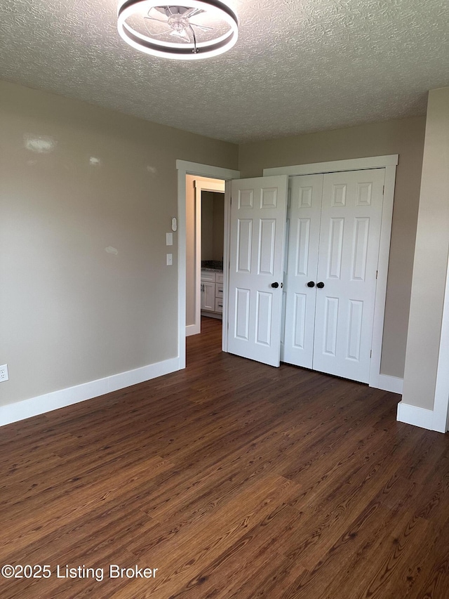 106 Sunflower Dr, Campbellsville, KY 42718 - unfurnished bedroom featuring dark wood finished floors, a textured ceiling, and a closet