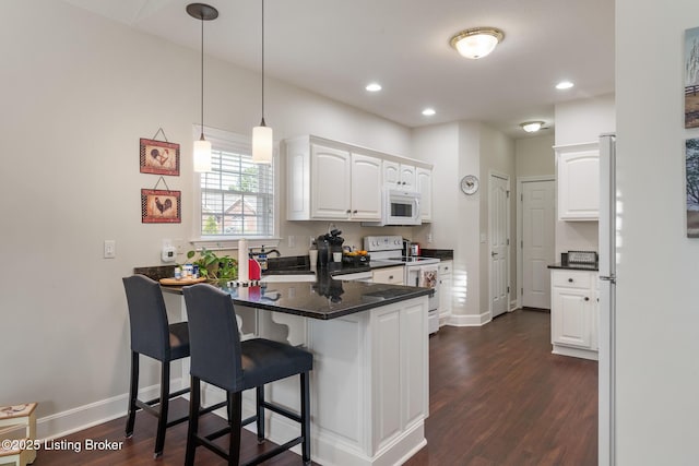 3105 Arbor Ridge Ln, New Albany, IN 47150 - kitchen featuring white appliances, a peninsula, white cabinetry, dark countertops, and a kitchen bar