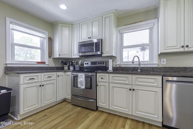 10703 Cedar Creek Rd, Louisville, KY 40229 - kitchen with appliances with stainless steel finishes, plenty of natural light, light wood-style flooring, white cabinetry, and recessed lighting