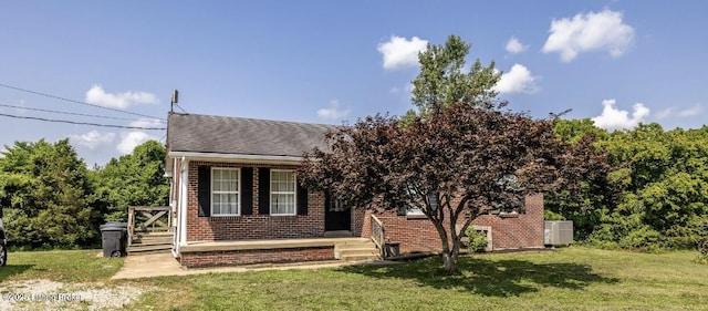 551 Tindale Dr, Taylorsville, KY 40071 - view of front of house with a front yard, brick siding, and roof with shingles