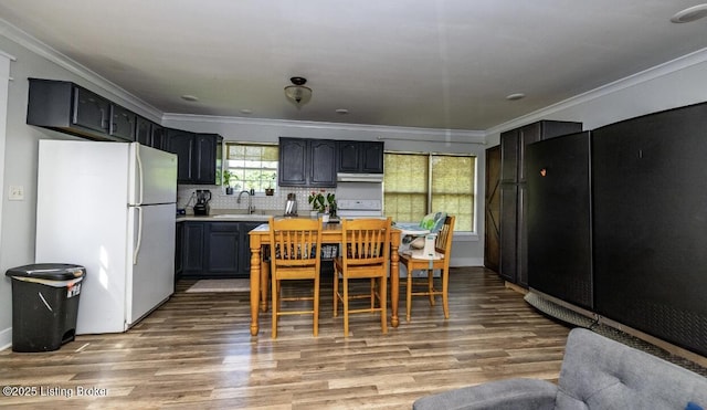 551 Tindale Dr, Taylorsville, KY 40071 - kitchen featuring freestanding refrigerator, ornamental molding, light wood-style floors, backsplash, and under cabinet range hood