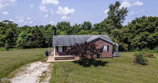551 Tindale Dr, Taylorsville, KY 40071 - view of front of house with a front lawn, brick siding, and a forest view