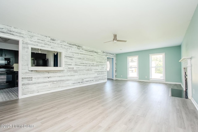 315 Tophill Dr, Shelbyville, KY 40065 - unfurnished living room featuring a ceiling fan, an accent wall, a fireplace with flush hearth, and wood finished floors