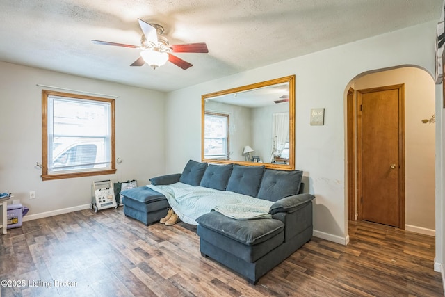 4418 Mann Ave, Louisville, KY 40215 - living area with arched walkways, wood finished floors, a ceiling fan, healthy amount of natural light, and a textured ceiling