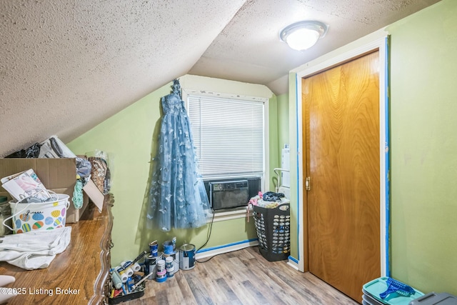 4418 Mann Ave, Louisville, KY 40215 - additional living space with wood finished floors, vaulted ceiling, cooling unit, and a textured ceiling