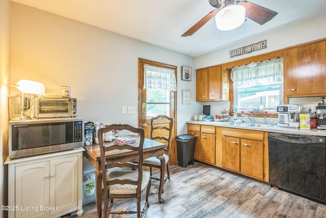 4418 Mann Ave, Louisville, KY 40215 - kitchen with black dishwasher, stainless steel microwave, a ceiling fan, and brown cabinetry