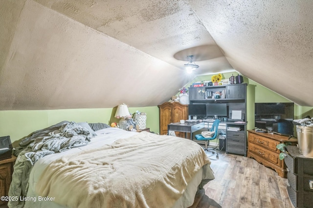 4418 Mann Ave, Louisville, KY 40215 - bedroom featuring wood finished floors, a textured ceiling, and vaulted ceiling