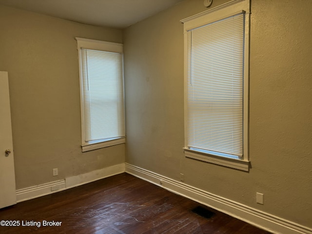 1851 Date St, Louisville, KY 40210 - empty room featuring dark wood-type flooring and baseboards