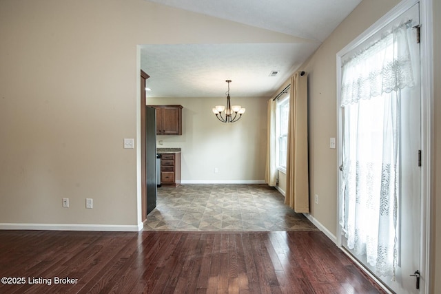128 Boone Trce, Radcliff, KY 40160 - unfurnished dining area with dark wood-style floors, a chandelier, and lofted ceiling