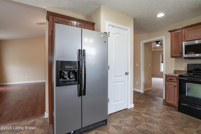128 Boone Trce, Radcliff, KY 40160 - kitchen with appliances with stainless steel finishes, recessed lighting, a ceiling fan, a textured ceiling, and light stone counters