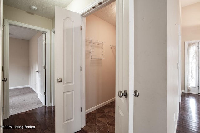 128 Boone Trce, Radcliff, KY 40160 - hallway featuring a textured ceiling and dark wood-type flooring