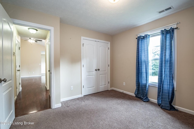 128 Boone Trce, Radcliff, KY 40160 - unfurnished bedroom with carpet flooring, a closet, and a textured ceiling