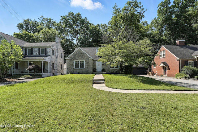 1724 Trevilian Way, Louisville, KY 40205 - view of front of house with a front yard, concrete driveway, stone siding, and a porch