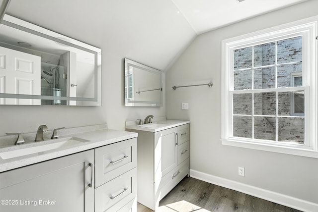 1724 Trevilian Way, Louisville, KY 40205 - full bath with two vanities, vaulted ceiling, wood finished floors, and healthy amount of natural light