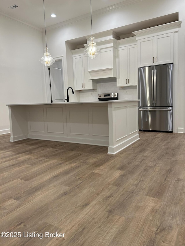 6355 Meeting St Unit 101, 201, Prospect, KY 40059 - kitchen featuring appliances with stainless steel finishes, wood finished floors, white cabinets, tasteful backsplash, and crown molding