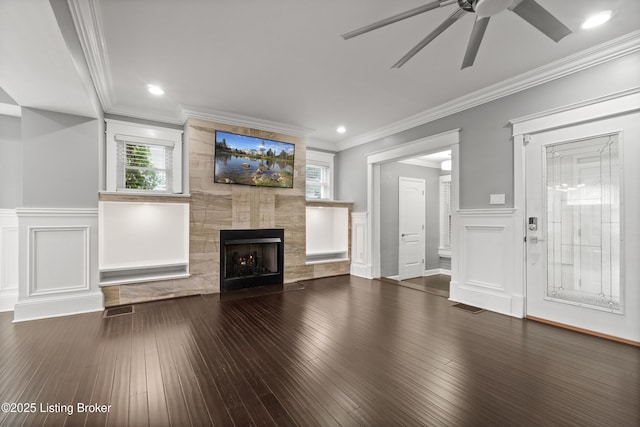 217 Shawnee Dr, Louisville, KY 40212 - unfurnished living room with a ceiling fan, a tile fireplace, a decorative wall, crown molding, and hardwood / wood-style floors