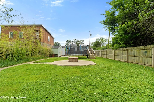217 Shawnee Dr, Louisville, KY 40212 - fenced backyard with a storage unit, an outdoor fire pit, and a patio