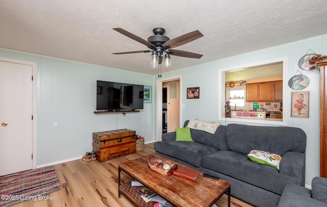 330 W Cardinal Ct, Madison, IN 47250 - living room featuring wood finished floors, a ceiling fan, and a textured ceiling