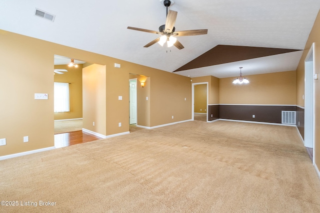 13702 Beowulf Ct, Louisville, KY 40299 - spare room featuring a ceiling fan, carpet flooring, vaulted ceiling, and a chandelier