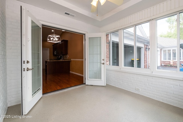 13702 Beowulf Ct, Louisville, KY 40299 - unfurnished sunroom with brick wall, a chandelier, and french doors