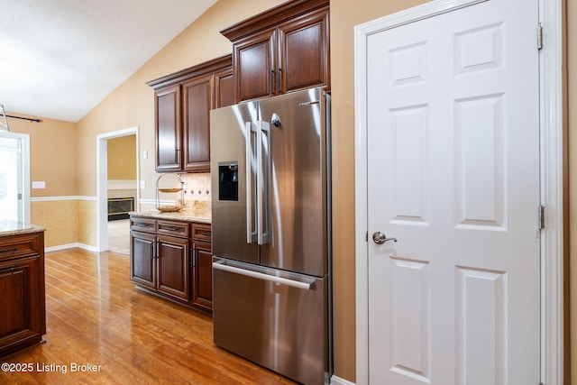 13702 Beowulf Ct, Louisville, KY 40299 - kitchen featuring stainless steel fridge with ice dispenser, lofted ceiling, light wood-style floors, light stone counters, and dark brown cabinets