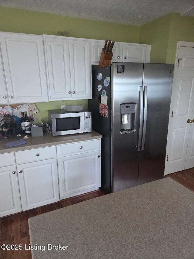 6911 Caitlynn Way, Louisville, KY 40229 - kitchen featuring stainless steel appliances, white cabinets, dark wood-type flooring, and light countertops