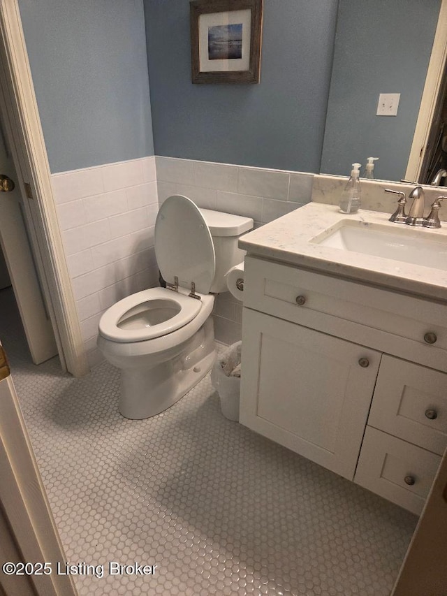 6911 Caitlynn Way, Louisville, KY 40229 - half bathroom featuring vanity, tile walls, wainscoting, and tile patterned flooring