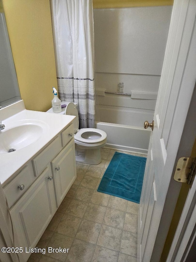 6911 Caitlynn Way, Louisville, KY 40229 - full bathroom featuring vanity, shower / bath combo with shower curtain, and stone finish floors