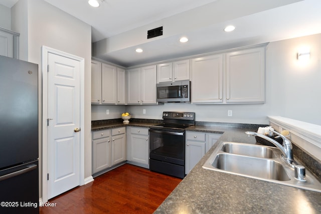 10600 Norton Commons Walk, Prospect, KY 40059 - kitchen featuring freestanding refrigerator, black electric range oven, stainless steel microwave, dark wood-style floors, and dark countertops