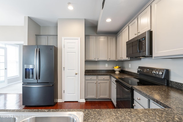 10600 Norton Commons Walk, Prospect, KY 40059 - kitchen with stainless steel fridge, black / electric stove, dark wood-style flooring, dark countertops, and recessed lighting