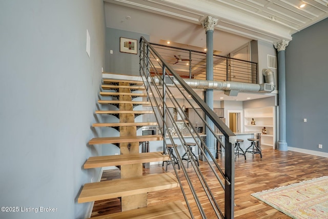 415 E Market St Unit 104, Louisville, KY 40202 - staircase featuring wood finished floors and a towering ceiling