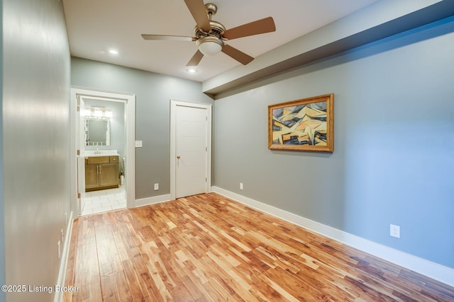 415 E Market St Unit 104, Louisville, KY 40202 - unfurnished bedroom featuring light wood-style flooring, recessed lighting, ensuite bathroom, and a ceiling fan