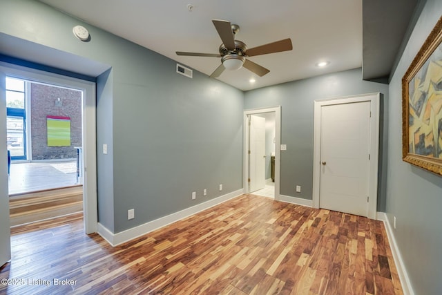 415 E Market St Unit 104, Louisville, KY 40202 - unfurnished bedroom featuring wood finished floors, recessed lighting, and ceiling fan
