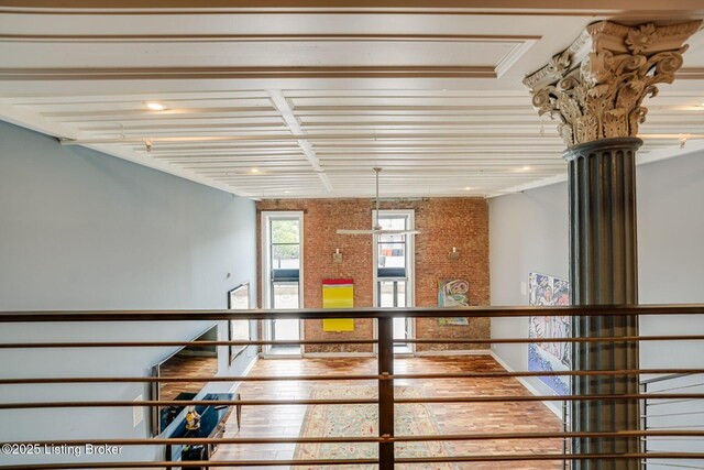 415 E Market St Unit 104, Louisville, KY 40202 - stairway featuring brick wall and hardwood / wood-style flooring