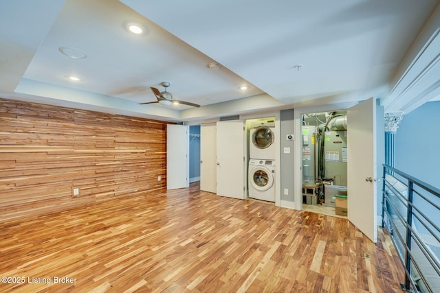 415 E Market St Unit 104, Louisville, KY 40202 - unfurnished bedroom with stacked washing machine and dryer, light wood-style flooring, water heater, recessed lighting, and a tray ceiling
