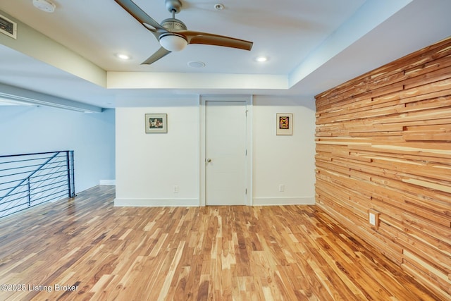 415 E Market St Unit 104, Louisville, KY 40202 - unfurnished room featuring light wood-style flooring, ceiling fan, a smoke detector, wooden walls, and recessed lighting