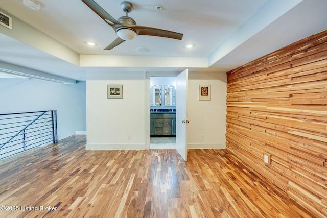 415 E Market St Unit 104, Louisville, KY 40202 - empty room with wood finished floors, a ceiling fan, a smoke detector, and wooden walls