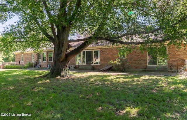 606 N Arbor Dr, Louisville, KY 40223 - rear view of property with a yard and brick siding