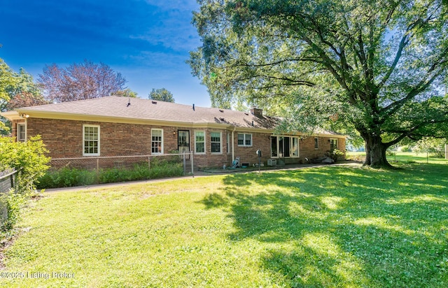 606 N Arbor Dr, Louisville, KY 40223 - back of house featuring a patio, brick siding, and a chimney
