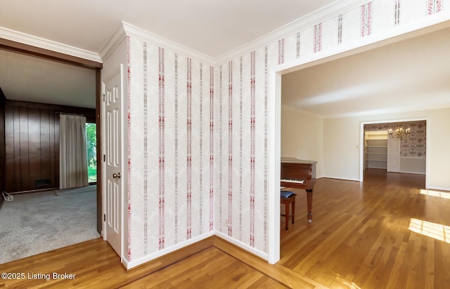 606 N Arbor Dr, Louisville, KY 40223 - corridor featuring wood finished floors, ornamental molding, and a chandelier