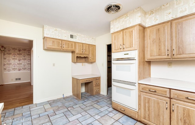 606 N Arbor Dr, Louisville, KY 40223 - kitchen with white double oven, wallpapered walls, light brown cabinets, and light countertops